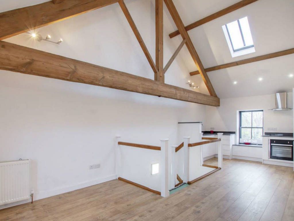 Interior living space with restored oak king post truss