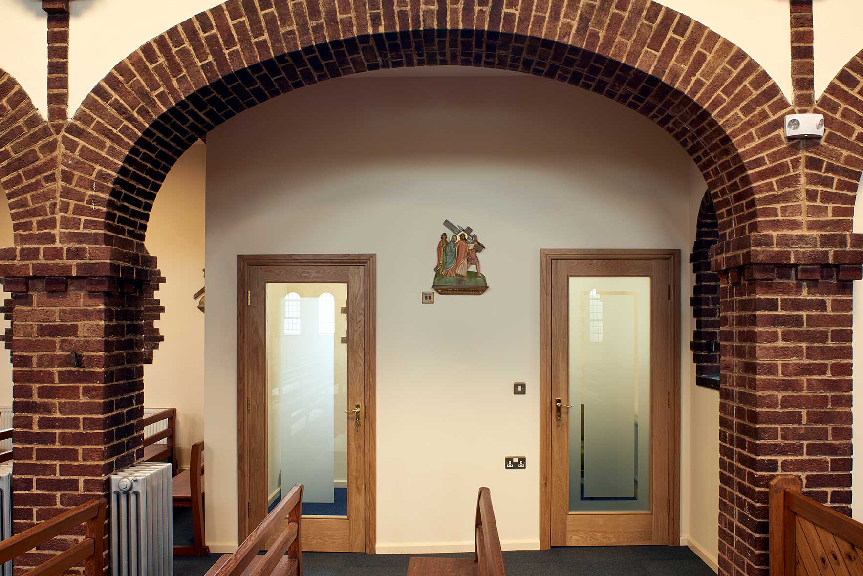 Confessional entrance beneath brick arch