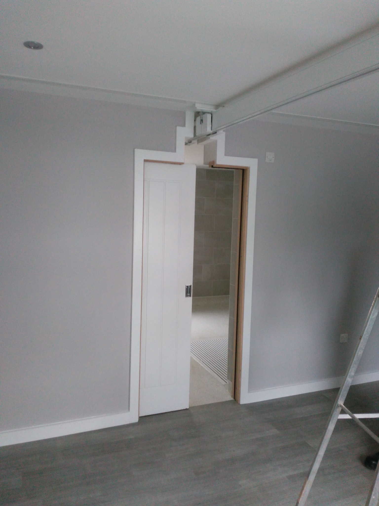 Accessible bedroom doorway with integrated ceiling-track hoist system