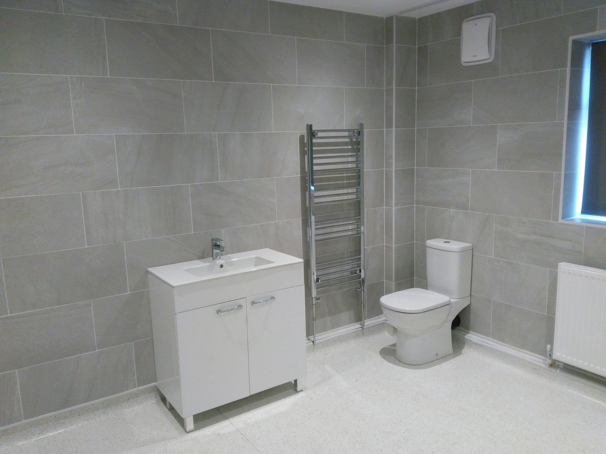 Completed accessible wet room with generous circulation space