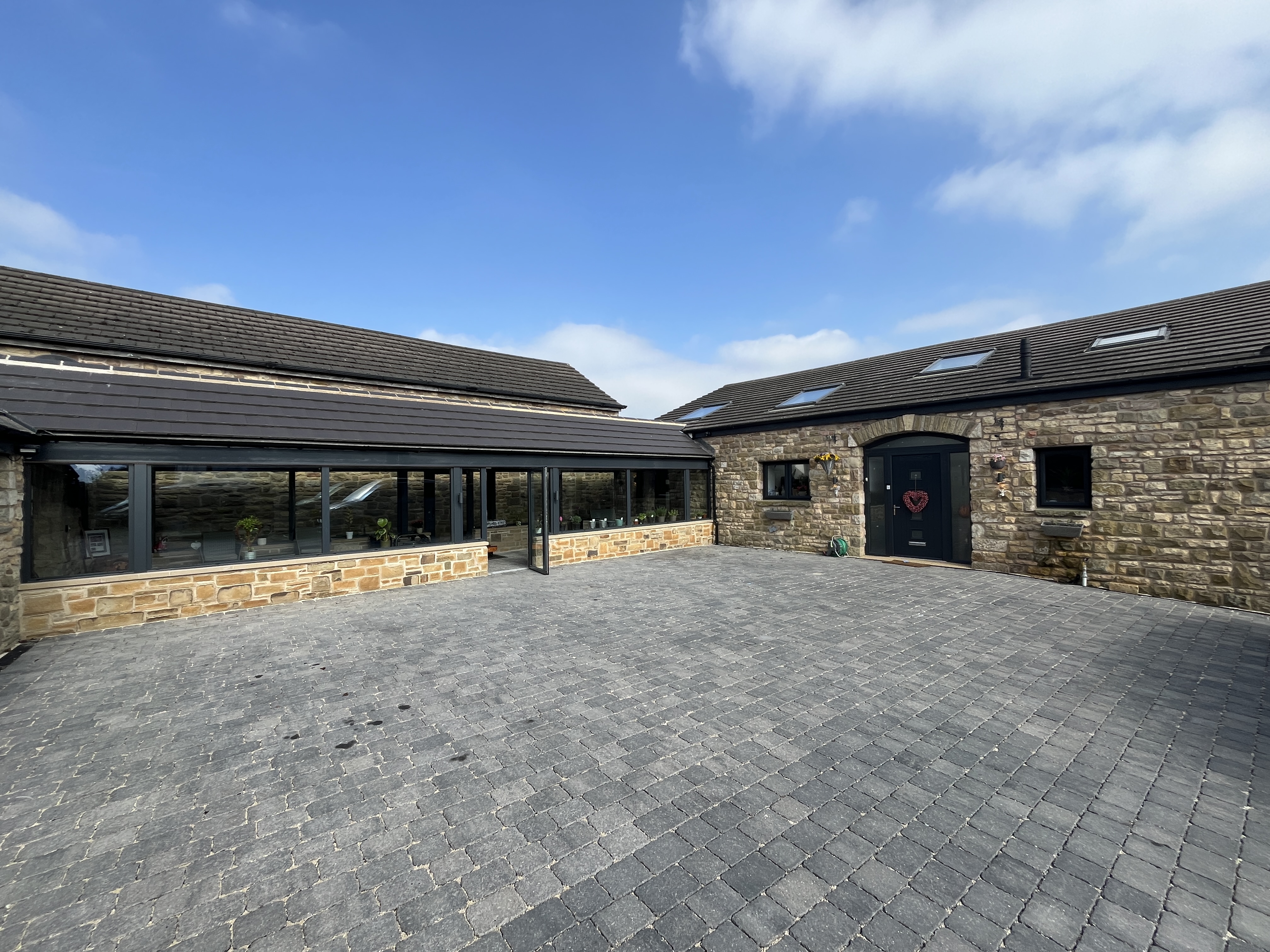 Accessible entrance with cobbled driveway