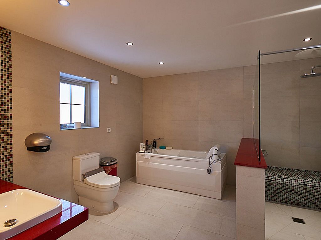Accessible bathroom with bath and level-access shower