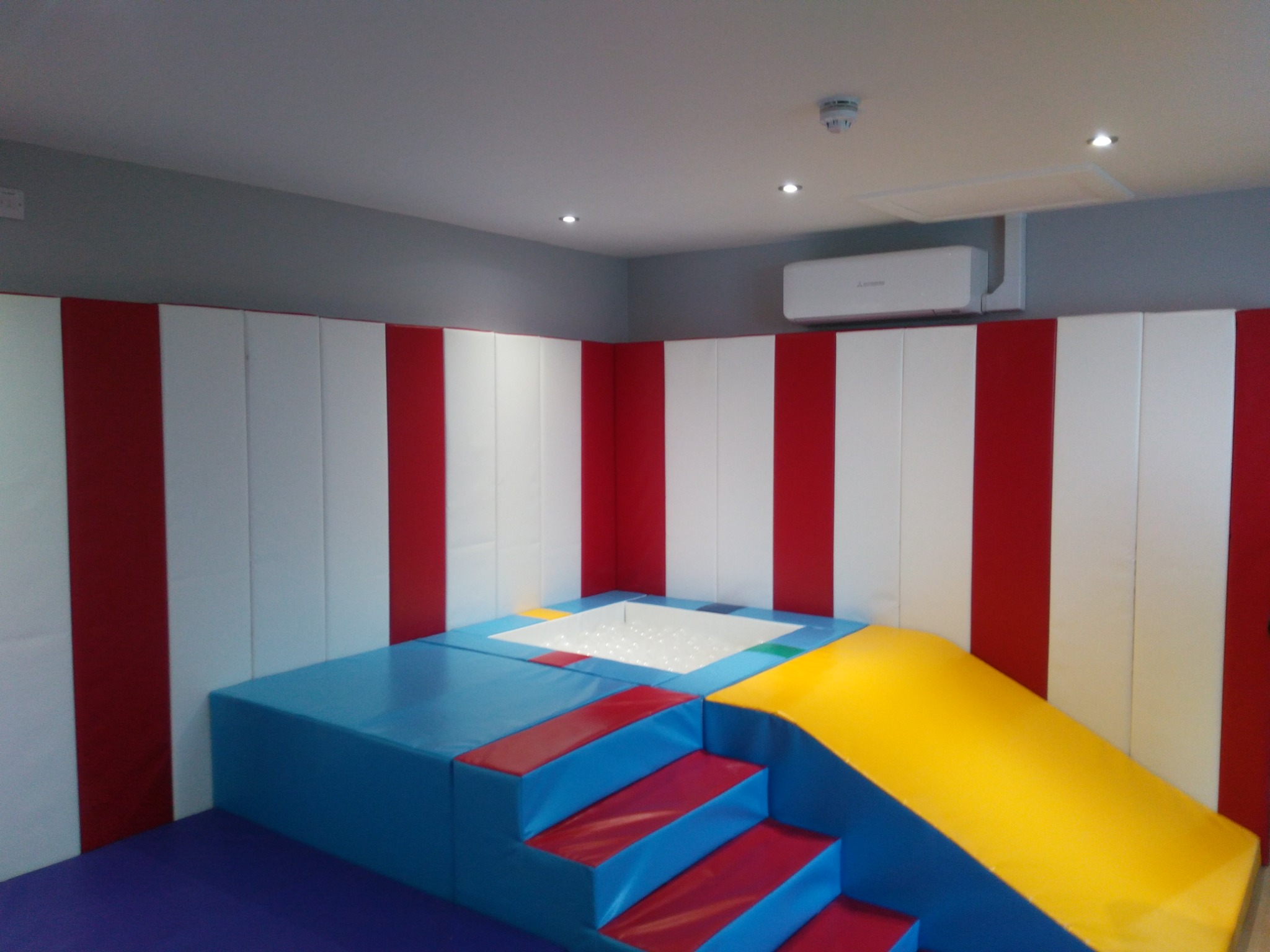 Specialist sensory room with soft play equipment and integrated lighting