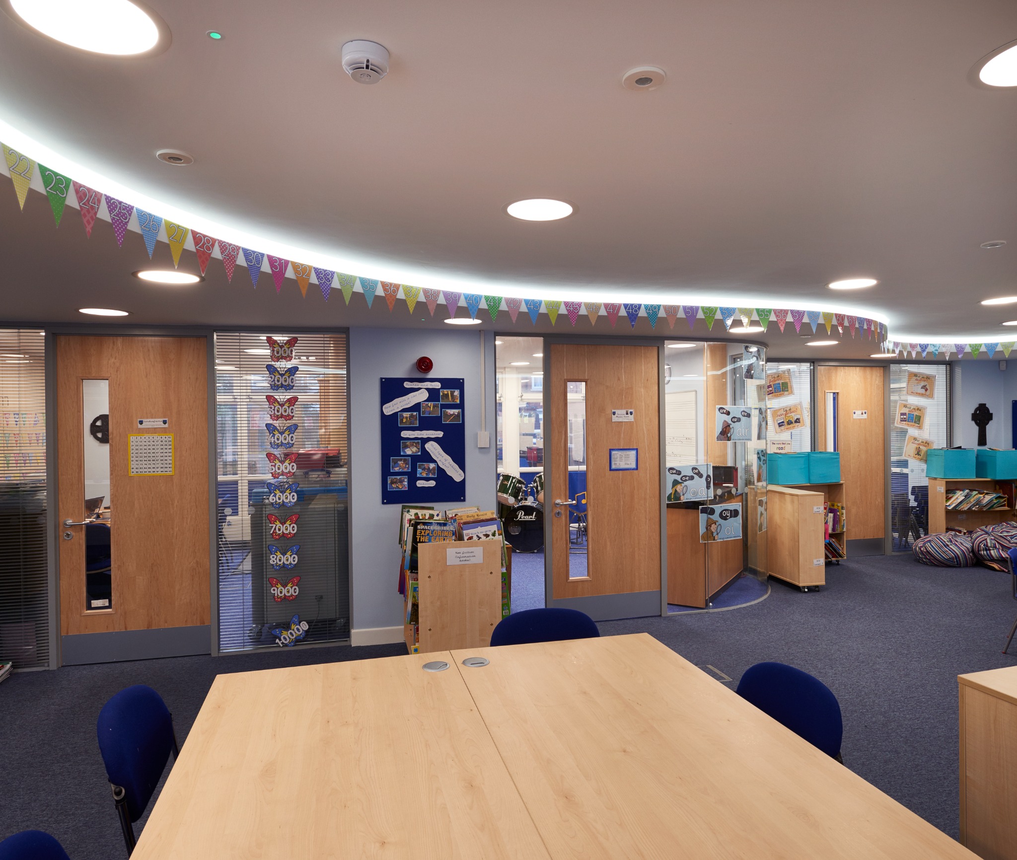 Library and learning zone with bespoke furniture and glazed rooms